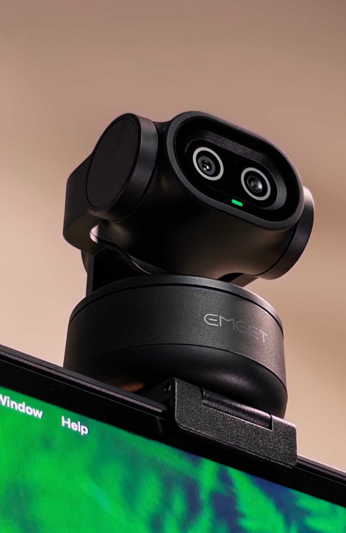 EMEET PIXY on top of a monitor, seen from below with its head turned to the right